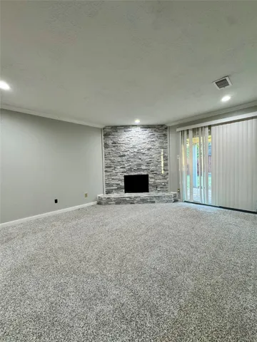 a view of empty room with a fireplace
