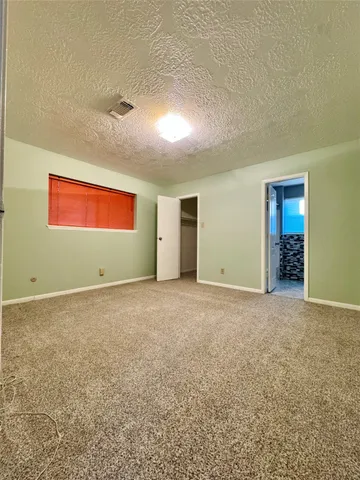 an empty room with an empty space and window