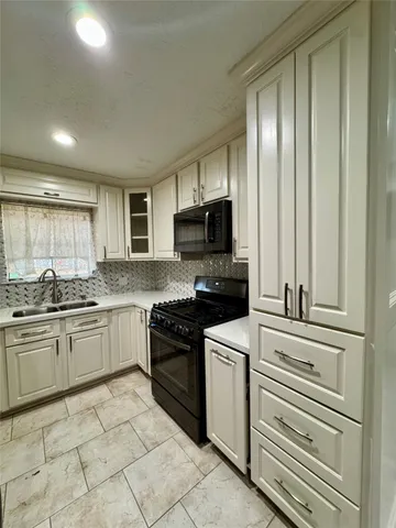 a kitchen with granite countertop stainless steel appliances and cabinets