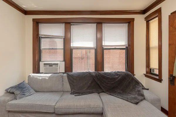 a living room with a bed furniture and a window