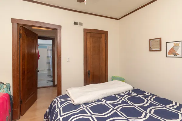 a bedroom with a bed and a mirror