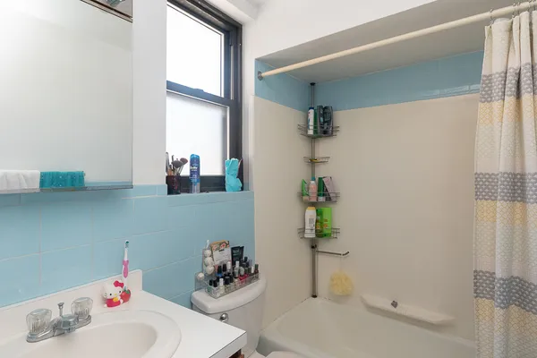 a bath room with a sink and a mirror