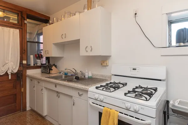 a kitchen with a sink a stove and a refrigerator