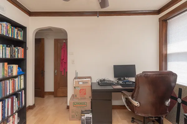 a view of a workspace with furniture and a bookshelf