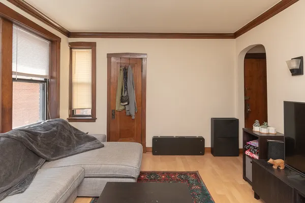 a bedroom with a bed tv and a window