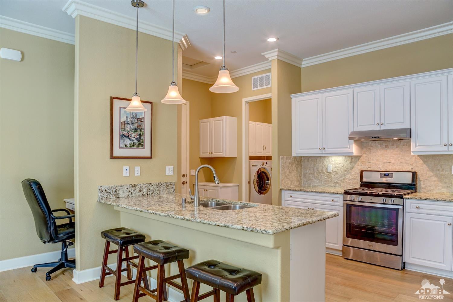 81340 Corte Compras Indio, CA 92203 - Photo 11 of 43 a kitchen with granite countertop a sink cabinets and stainless steel appliances