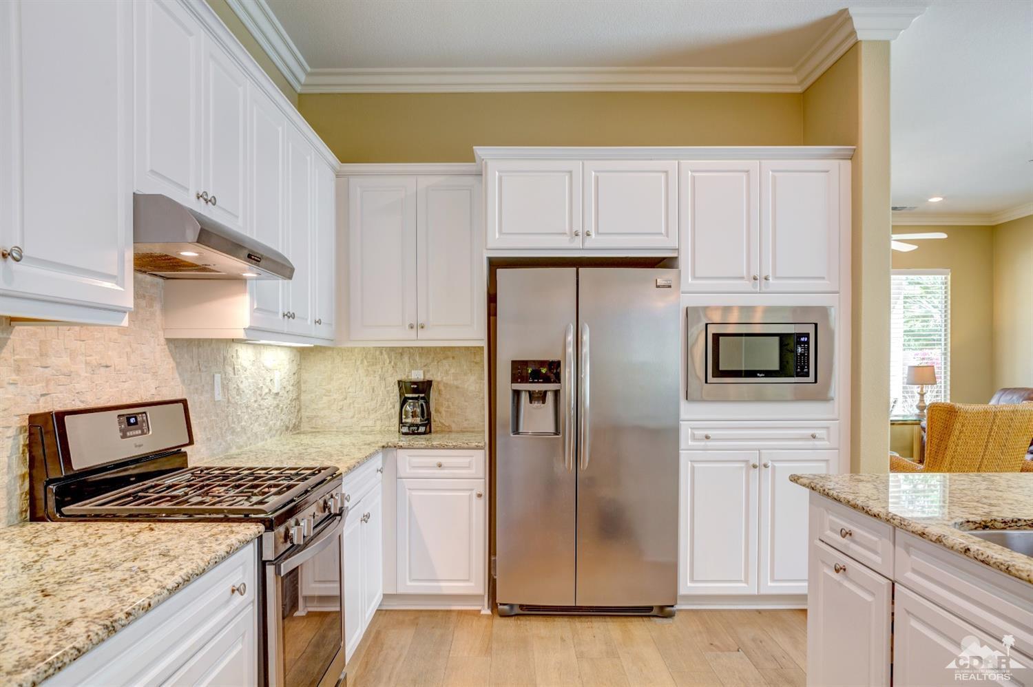 81340 Corte Compras Indio, CA 92203 - Photo 13 of 43 a kitchen with stainless steel appliances granite countertop a stove a refrigerator and a white cabinets