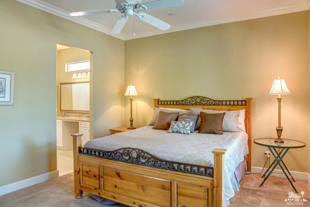 a bedroom with a bed and lamp with cabinets