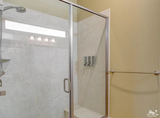 a bathroom with a glass shower door