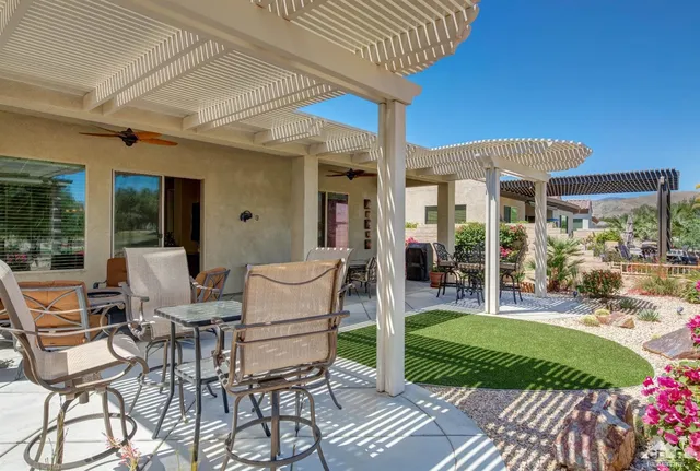a view of a patio with a table chairs and a patio