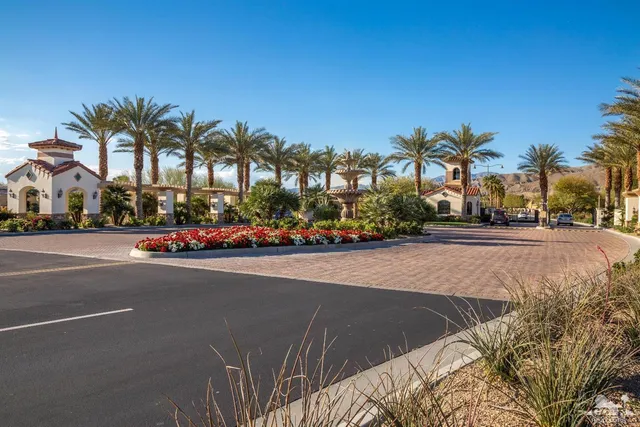 a street with a building and palm trees