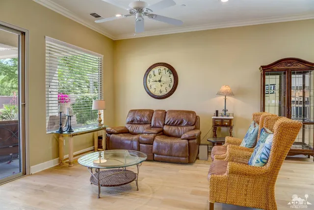 a living room with furniture a table and a large window