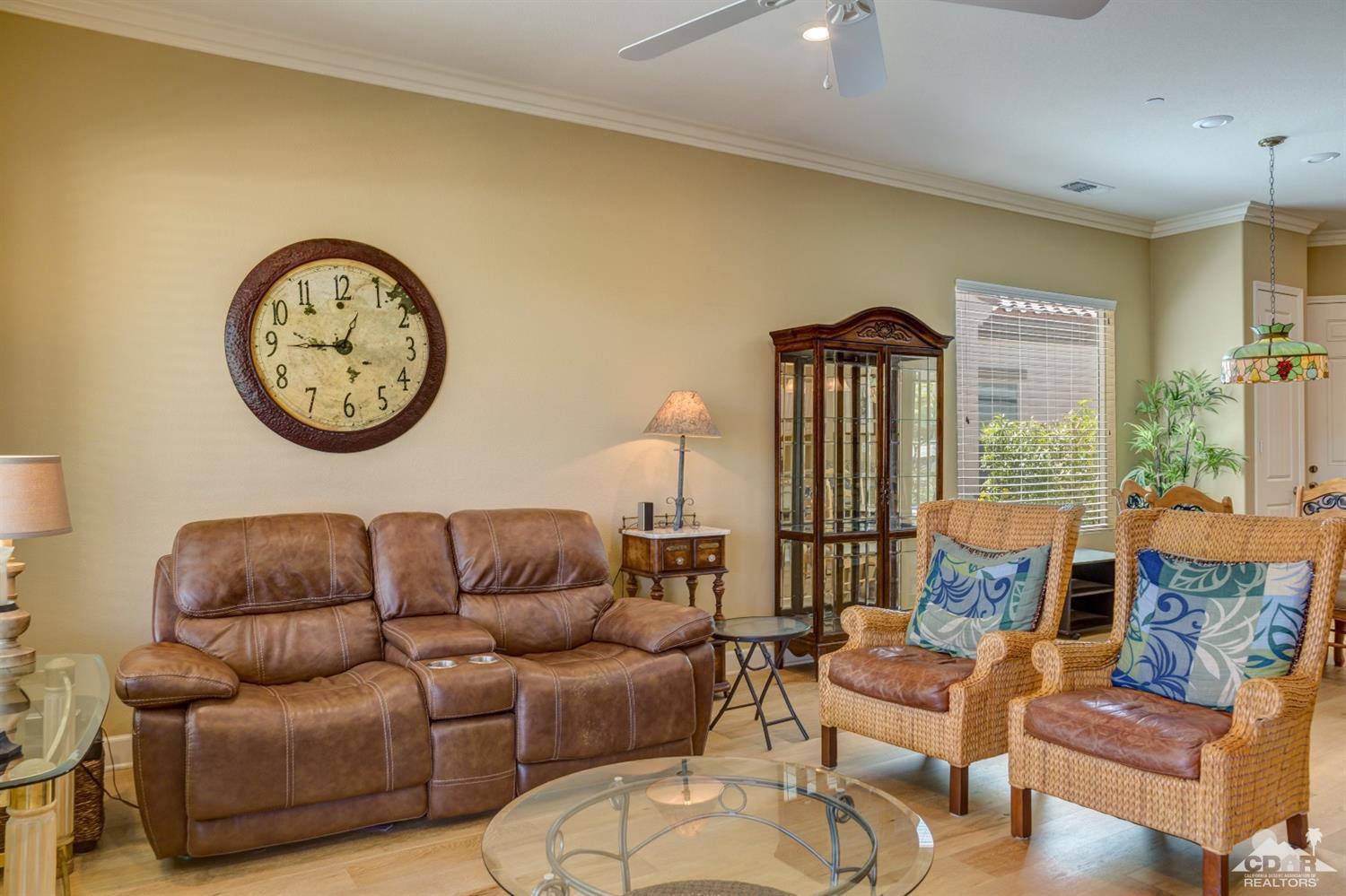 81340 Corte Compras Indio, CA 92203 - Photo 5 of 43 a living room with furniture a clock on wall and a large window
