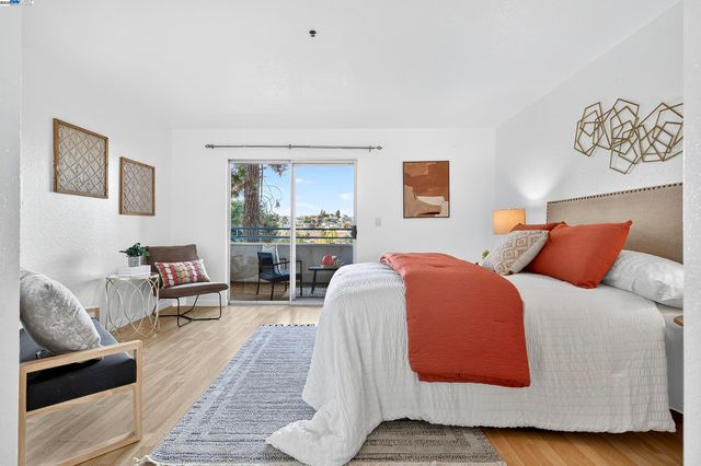 a view of a balcony with dining table and chairs