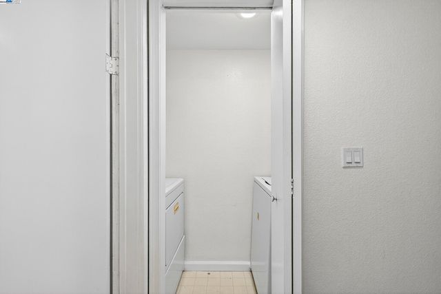 a bedroom with a bed and a walk in closet with wooden floor