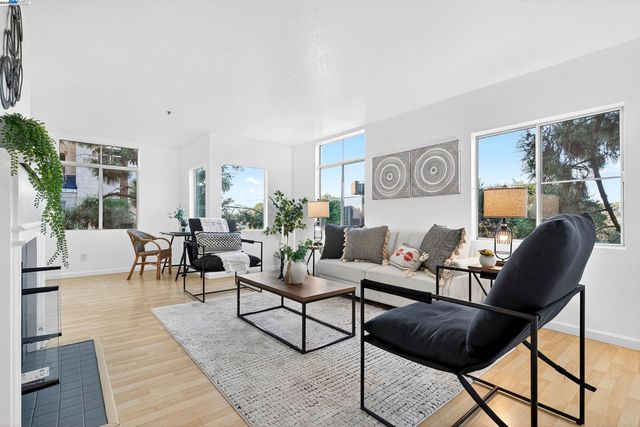 a living room with furniture a fireplace and a table