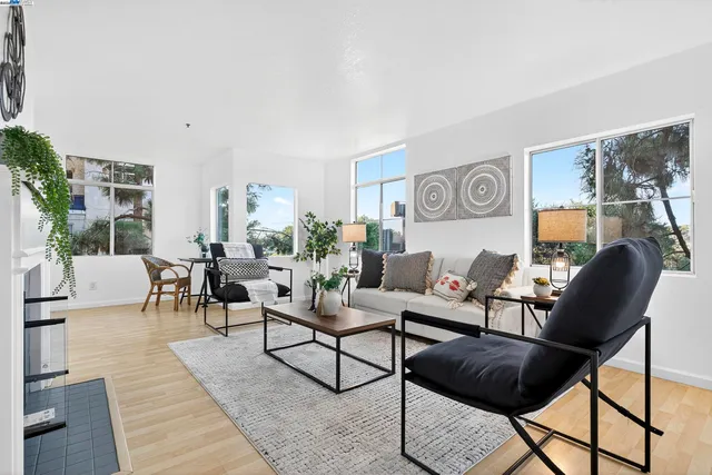 a living room with furniture a fireplace and a table