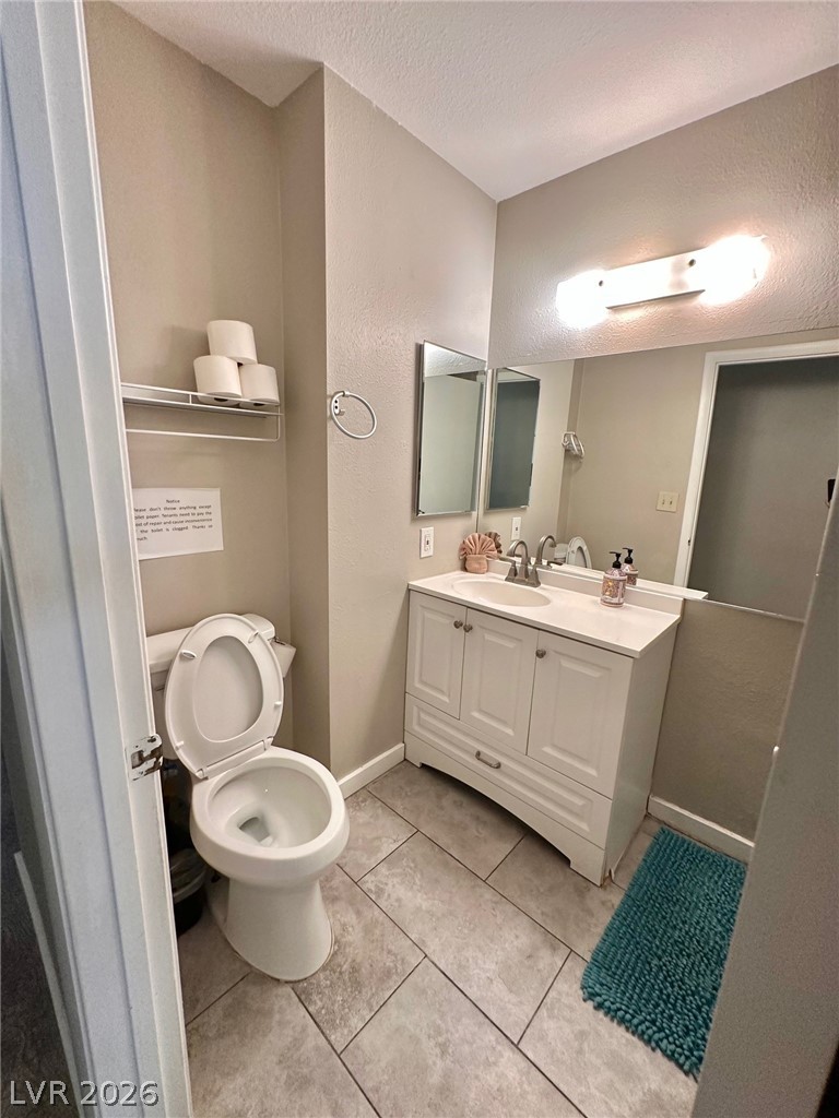 2340 Viewcrest Road Henderson, NV 89014 - Photo 23 of 36 This functional bathroom offers a bright vanity and tiled flooring for everyday comfort.