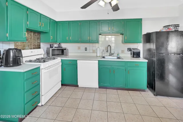 a kitchen with a cabinets a sink and appliances