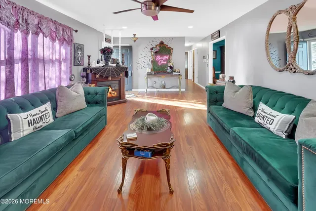 a dining room with furniture window and wooden floor