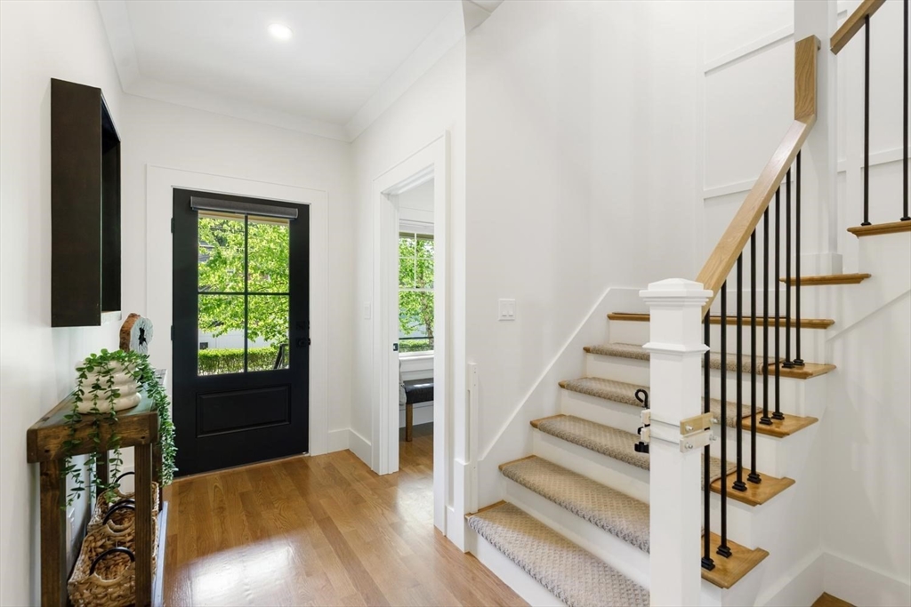 1124 Chestnut Street Newton, MA 02464 - Photo 12 of 41 a view of entryway with wooden floor and stairs