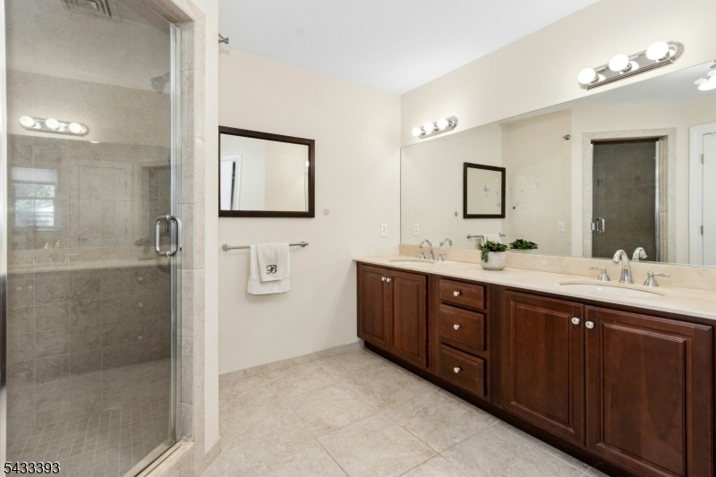 33 Stanton Street Clark, NJ 07066 - Photo 23 of 37 a bathroom with a double vanity sink mirror and shower