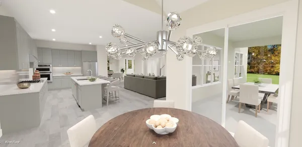 a very nice looking dining room with kitchen island a table and a chandelier
