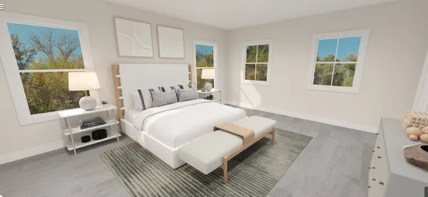 a bed room with a bed a couch and two windows