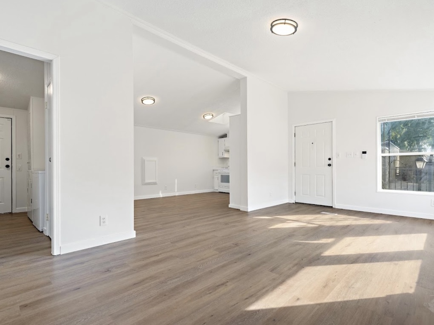 1052 Lake Terrace Road Elgin, IL 60123 - Photo 2 of 9 an empty room with wooden floor and windows