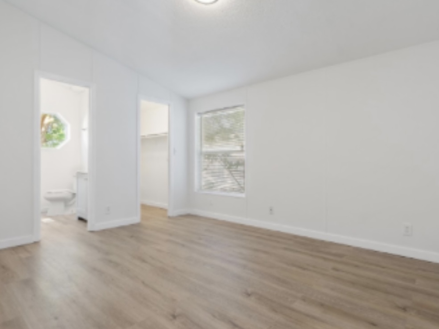 1052 Lake Terrace Road Elgin, IL 60123 - Photo 4 of 9 a view of an empty room with wooden floor and a window