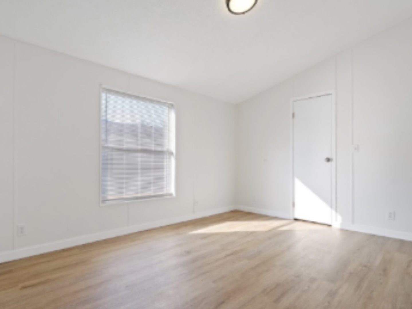 1052 Lake Terrace Road Elgin, IL 60123 - Photo 5 of 9 an empty room with wooden floor and windows