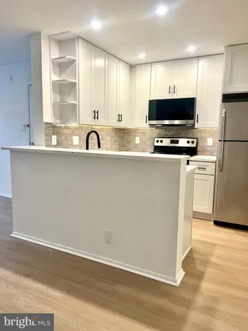 a view of a kitchen with microwave and cabinets