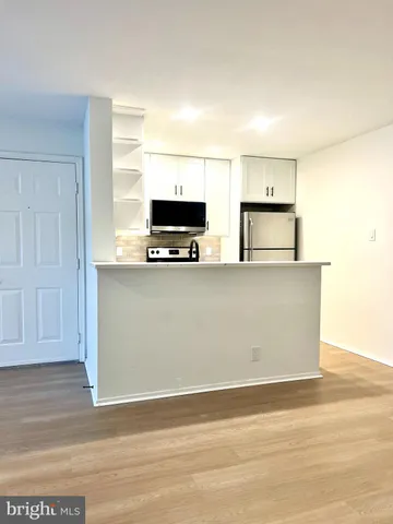a living room with a flat screen tv and a window