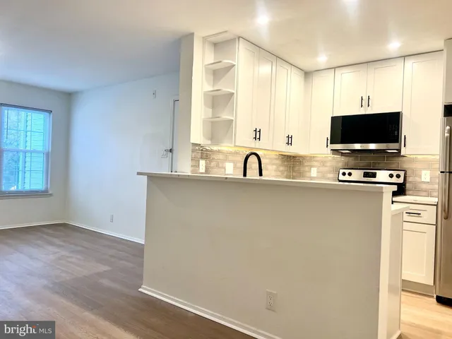 a view of a room with wooden floor and sink