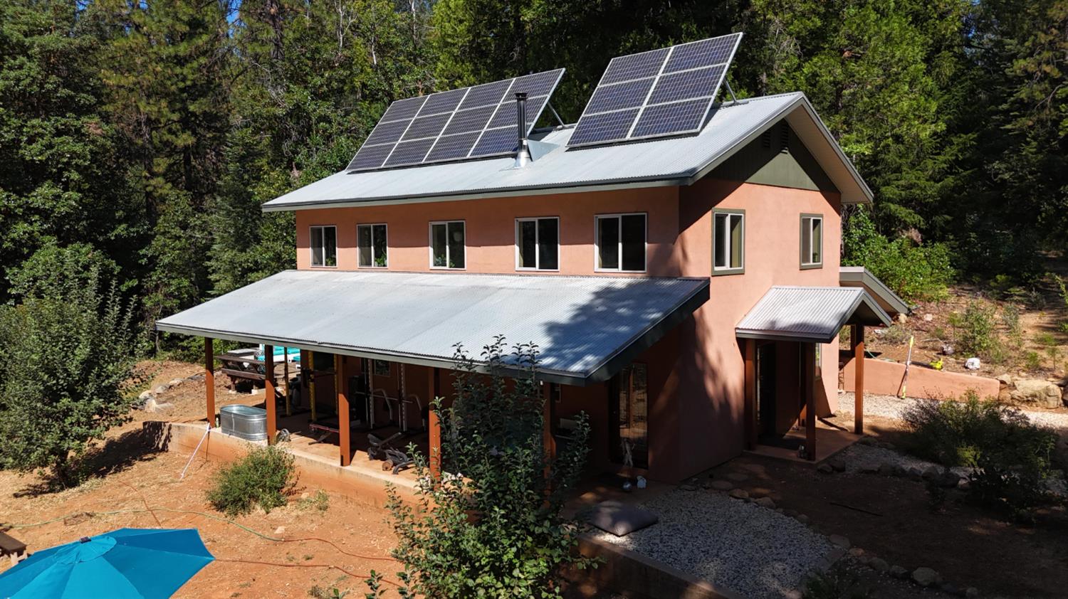 a front view of house with yard and trees around