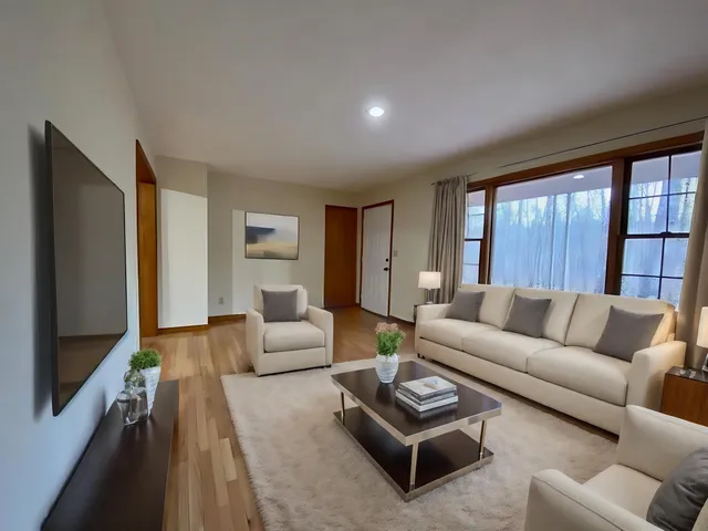 a view of a dining room with furniture a kitchen and chandelier