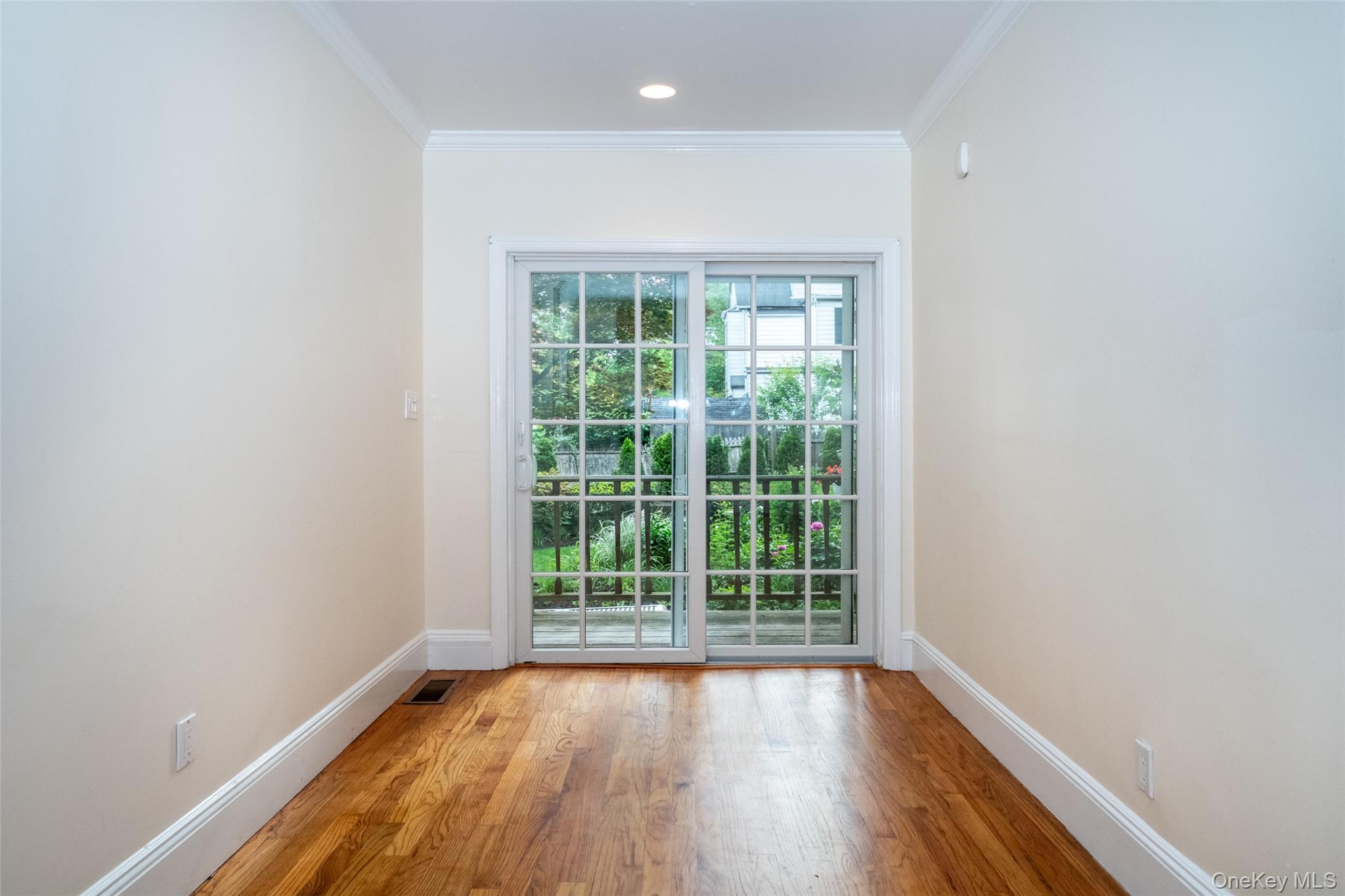 82 Clove Road New Rochelle, NY 10801 - Photo 5 of 39 an empty room with wooden floor and windows