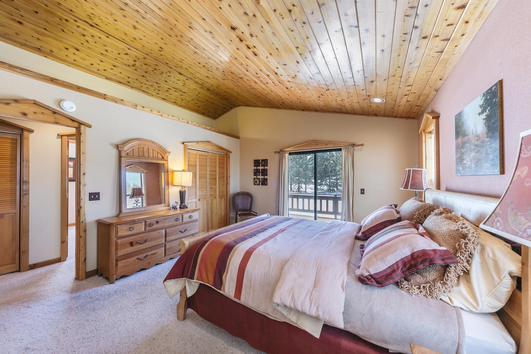 14514 Wolfgang Road Truckee, CA 96161 - Photo 11 of 21 a bedroom with a large bed and wooden floor