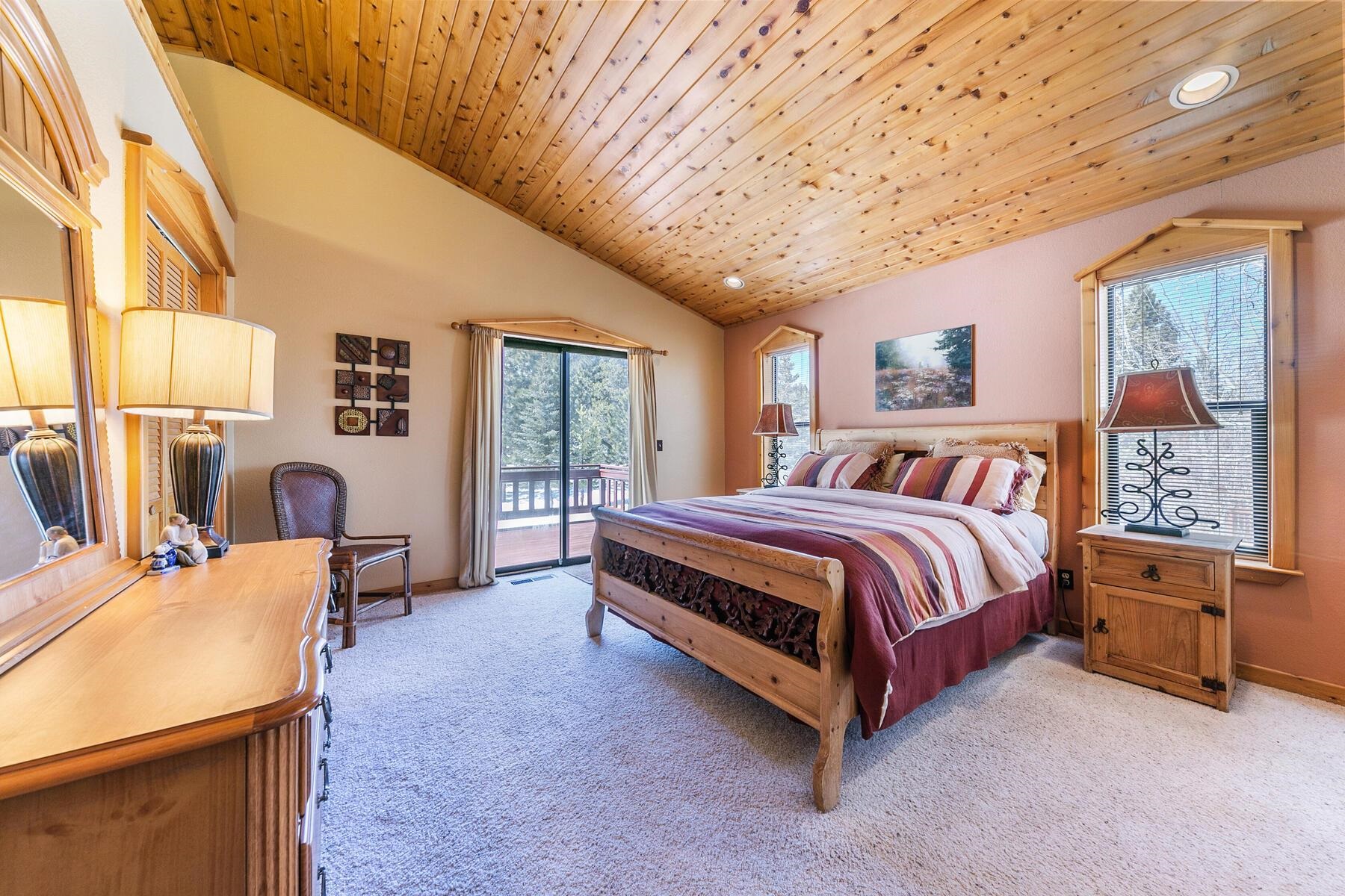 14514 Wolfgang Road Truckee, CA 96161 - Photo 12 of 21 a bedroom with a bed and dresser with mirror