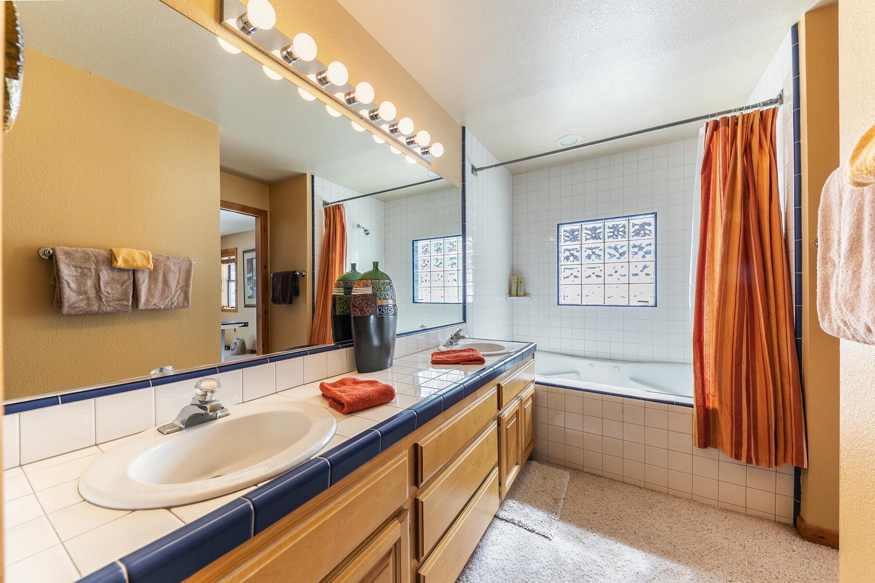 14514 Wolfgang Road Truckee, CA 96161 - Photo 19 of 21 a bathroom with a sink double vanity granite tub and shower