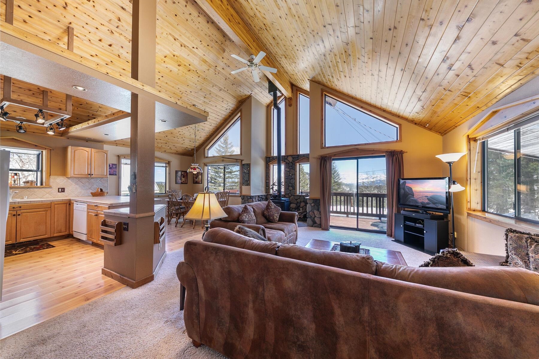 14514 Wolfgang Road Truckee, CA 96161 - Photo 3 of 21 a living room with furniture a fireplace and a large window