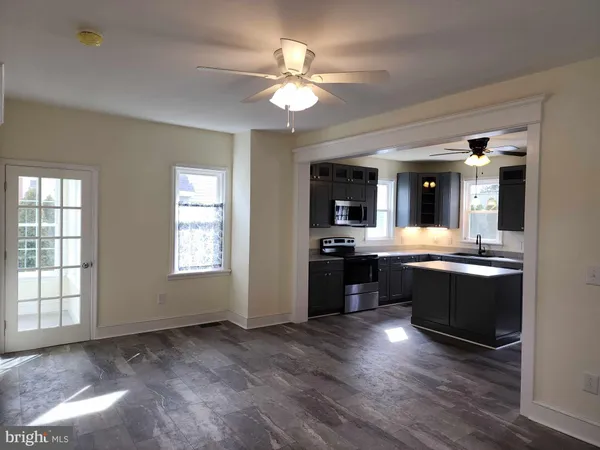 a large open kitchen with a stove a sink and a refrigerator
