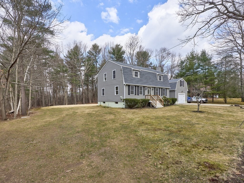75 J J Davis Road Charlton, MA 01507 - Photo 6 of 33 a front view of a house with a yard and large trees