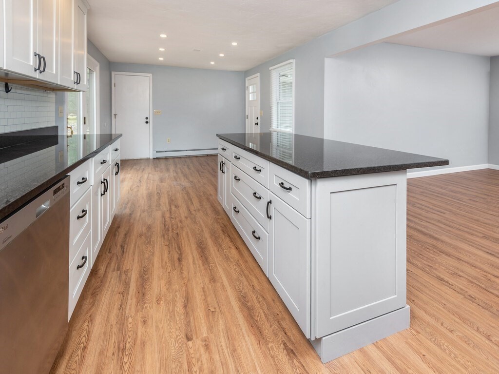 75 J J Davis Road Charlton, MA 01507 - Photo 10 of 33 a kitchen with granite countertop a sink and a stove top oven