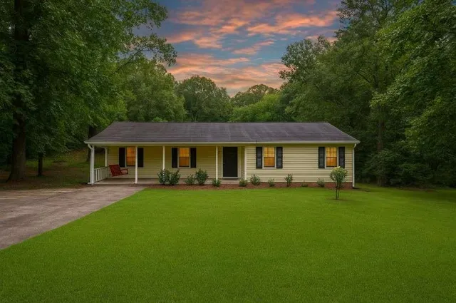 a front view of a house with a garden