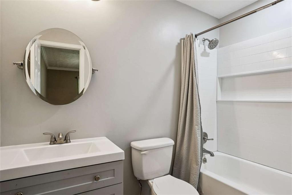183 Elm Street Covington, GA 30014 - Photo 12 of 23 a bathroom with a toilet sink and mirror