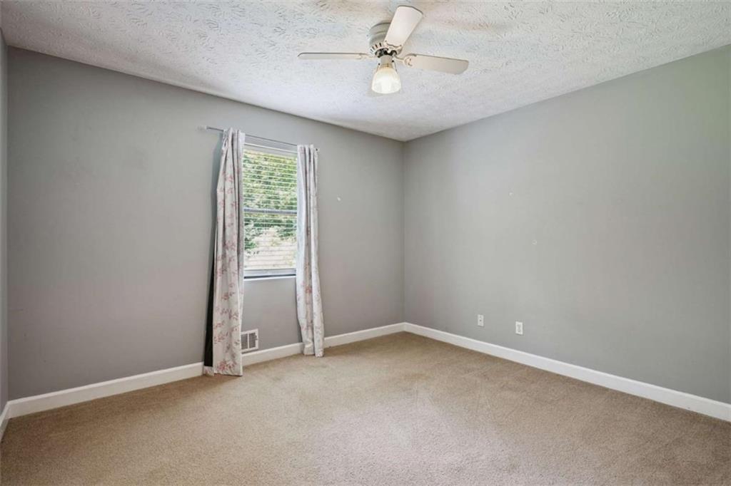 183 Elm Street Covington, GA 30014 - Photo 13 of 23 an empty room with a window