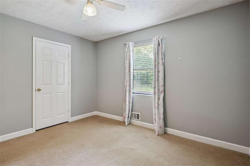 183 Elm Street Covington, GA 30014 - Photo 14 of 23 an empty room with windows