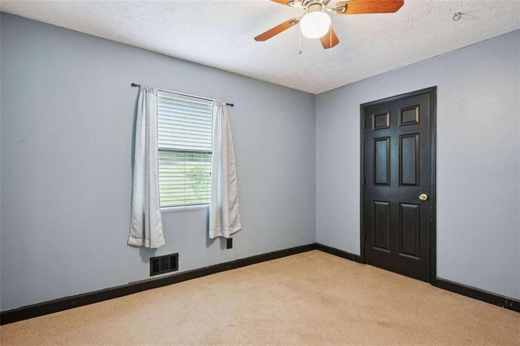 183 Elm Street Covington, GA 30014 - Photo 17 of 23 a view of an empty room with a window