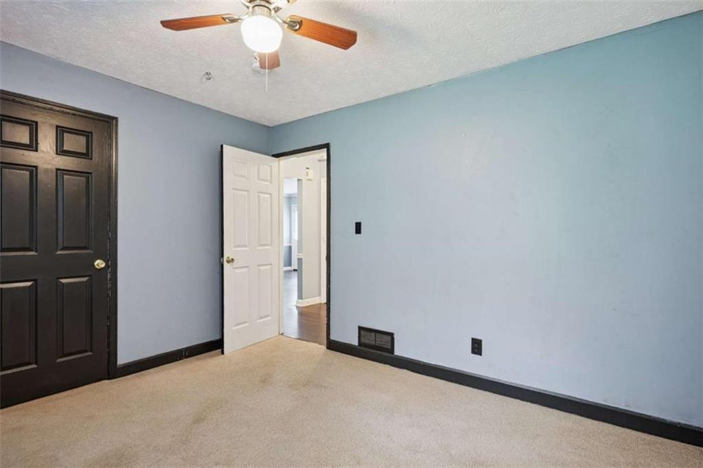 183 Elm Street Covington, GA 30014 - Photo 18 of 23 an empty room with a ceiling fan